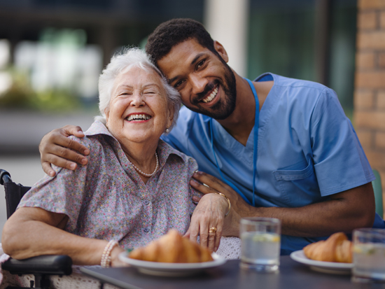 A caregiver providing companion care support to a client at home