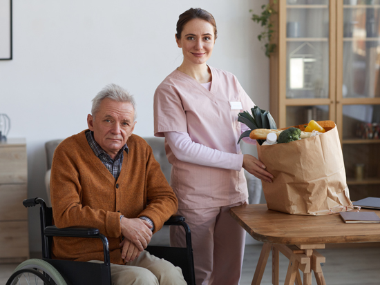 A caregiver providing daily living assistance support to a client at home
