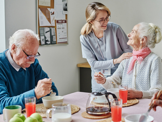A caregiver providing homemaking services support to a client at home