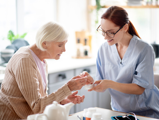 A caregiver providing senior care support to a client at home